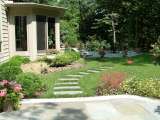 Stone walk connects two patios in backyard of Gates Mills Ohio residence